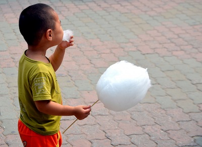 young boy eating candy floss candy floss