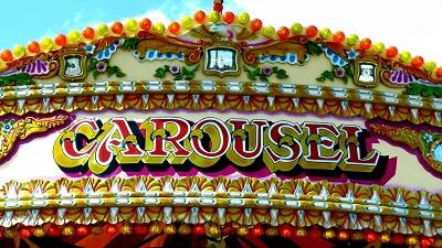 Painted sign for a Carousel Merry Go Round Carousel funfair sign